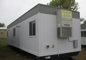 A white trailer with a yellow sign on it.