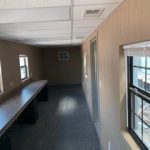 A room with two windows and a table