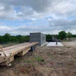 A construction site with a truck and trailer.