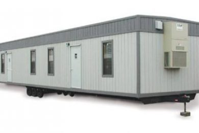 A trailer with two windows and a door.