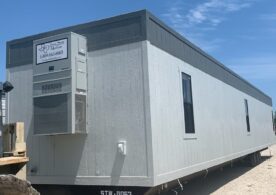 A trailer with a large window and a door.