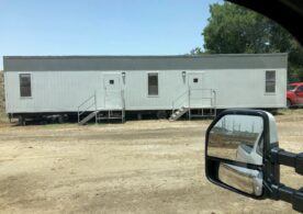 A trailer with stairs in the back of it.