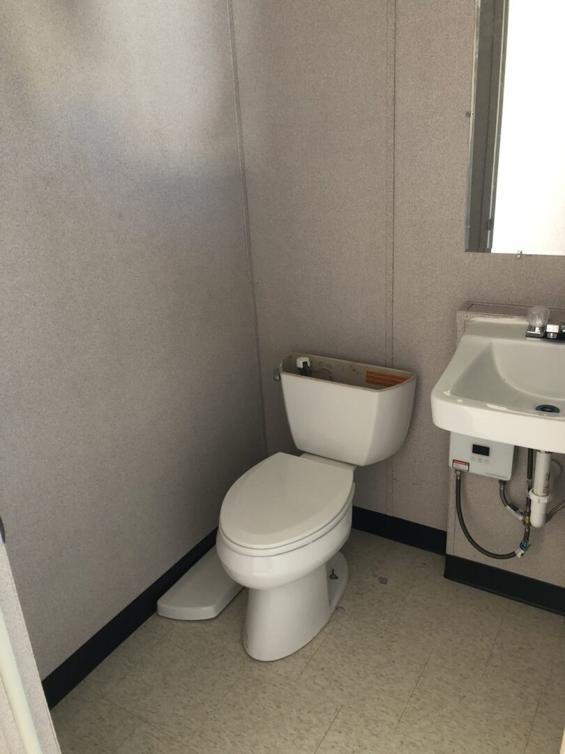 A bathroom with a toilet and sink in it