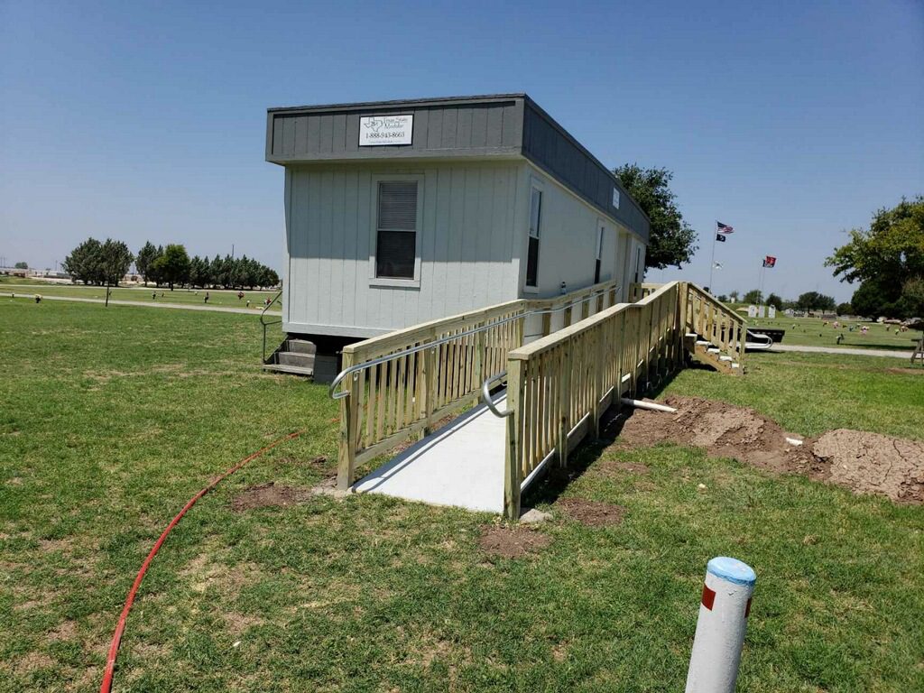 A ramp leading to the side of a house.