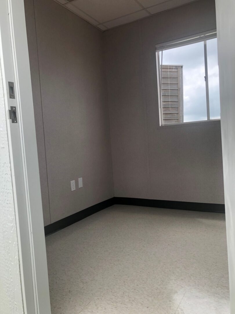 A room with a window and a door.