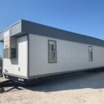 A trailer with a large window and door.