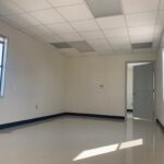 A room with white walls and a large window.