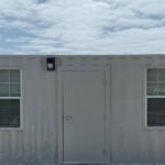 A white container with two windows and door.