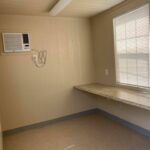 A room with a window and a desk in it