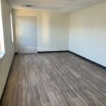 A room with wood floors and white walls.