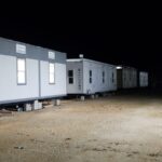 A row of mobile homes on the side of a road.