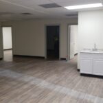 A room with white walls and wooden floors.