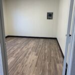 A room with wood floors and white walls.